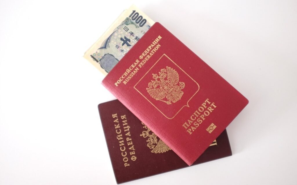 Russian passports with Japanese yen inside, symbolizing international travel, immigration, and customs clearance.